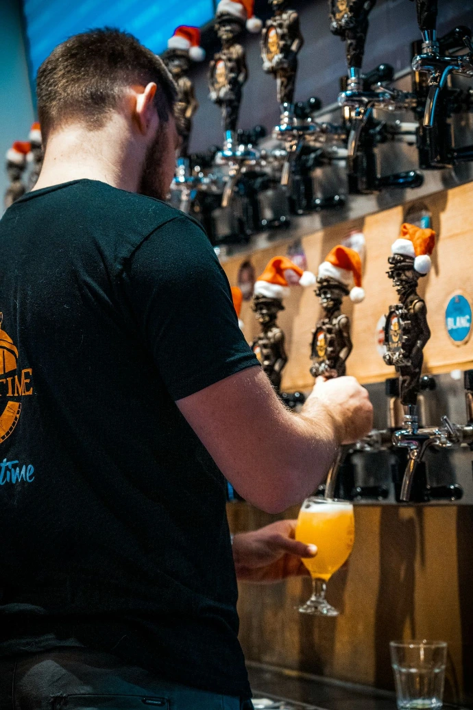 A man holding a glass of orange juice